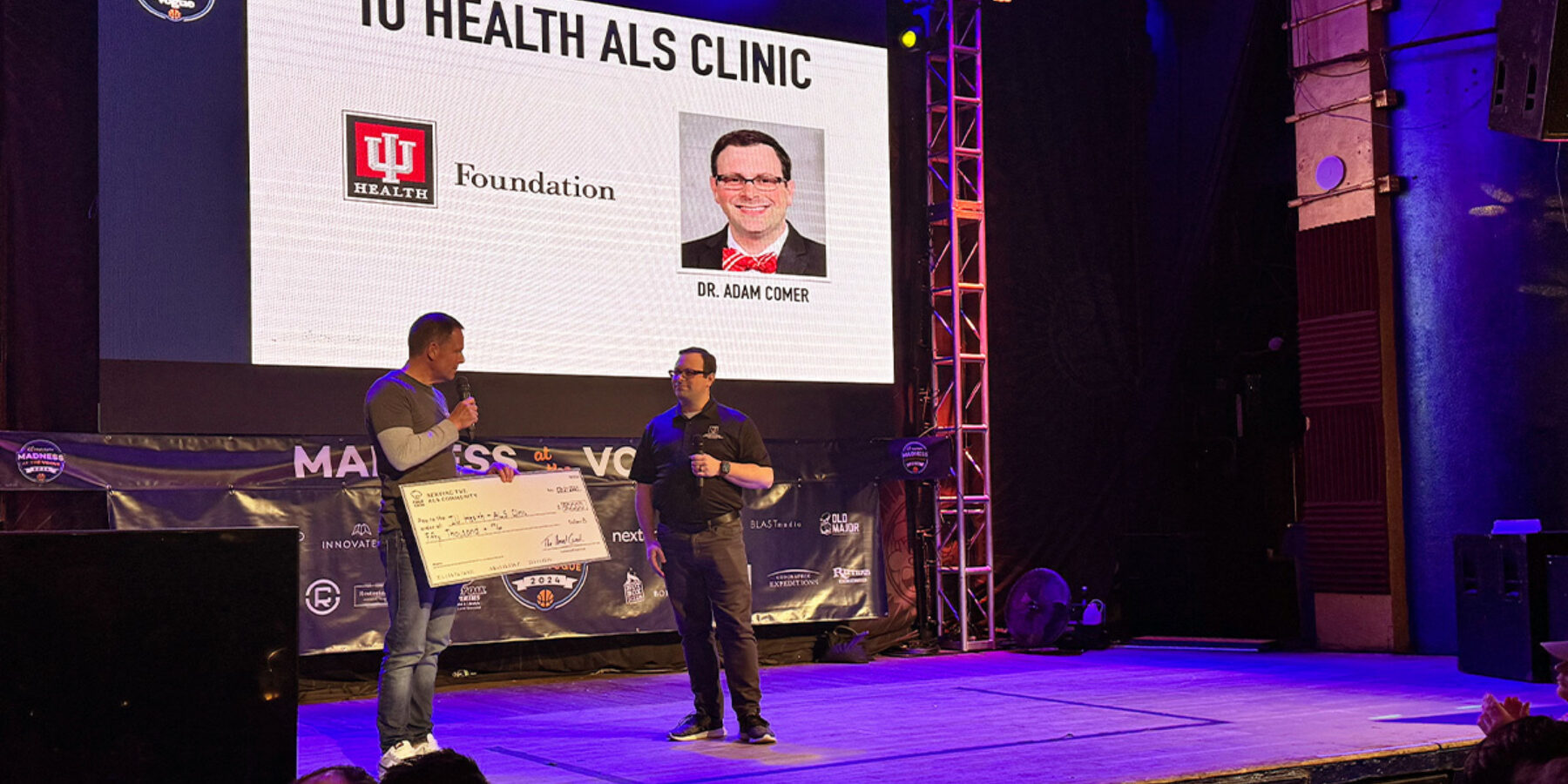 Mike Fizgerald presenting check to Dr Adam Comer